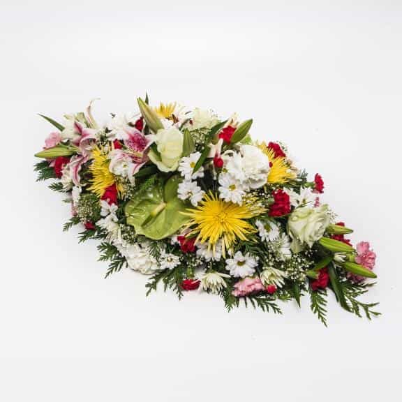 <p>A beautiful large colourful Arrangement to celebrate ones life.</p><p>Created using a range of fresh flowers including Lilies, Roses, Chrysanthemums and Carnations. Measuring approximately 75cm long (2.5 feet) this arrangement is ideally suited for a funeral remembrance. </p><p>If particular flowers or colours are required simple request them during the checkout stage.</p>