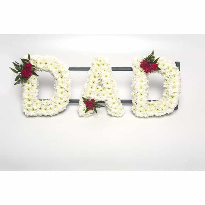 <p>A fitting tribute to a much missed Dad. This stand out tribute is created using a mass of white double chrysanthemums and finished with a small "spray" of red roses on one corner of each letter.</p><p>Each letter measures approximately 30cm high and approximately 15 wide.</p><p>If you would like this done in different colours please contact us.</p>