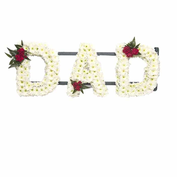 <p>Create your own personal name or message, for a personal tribute during a time of grief and remembrance. Each letter measures approximately 30cm high and 15cm wide.</p><p>Finished normally using a mass of white double chrysanthemums and detailed using roses.</p><p>Contact us directly to discuss your exact requirements, we stock a complete range of frames and can create any text you require </p>