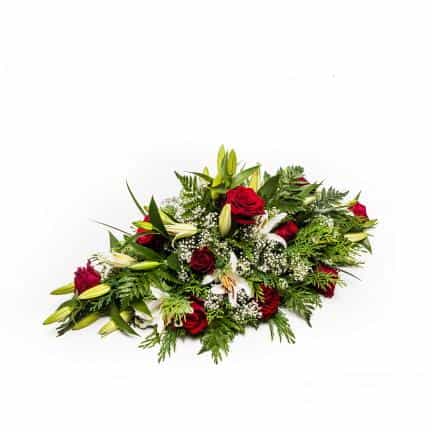 <p>A beautiful arrangement expertly crafted using the finest "Gran Prix" Red Roses and classic White Orential Lilies.</p><p>Sitting approximately 60cm long (2 feet) long this tribuate is ideal for remembrance of a birthday, anniversary or funeral.</p>