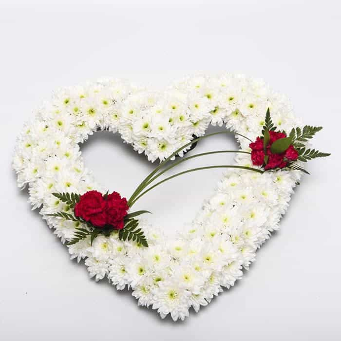 <p>A tribute to a love gone but not forgotten.</p><p>Finished here in a mass of white double chrysanthemums with red roses, this arrangement measures 45cm across (17") and can be decorated in different colours or styles if required.</p><p>Ideal for the remembrance of a loved one.</p><p>Simply contact us.</p><p> </p>